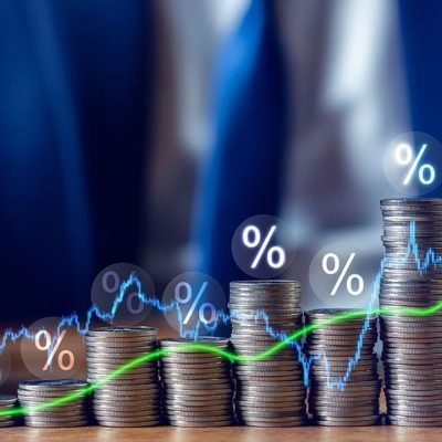 Businessman putting down money, pointing with pen and showing candlestick symbol for investing, finance, saving money, interest rate or dividend investment, business growth concept.